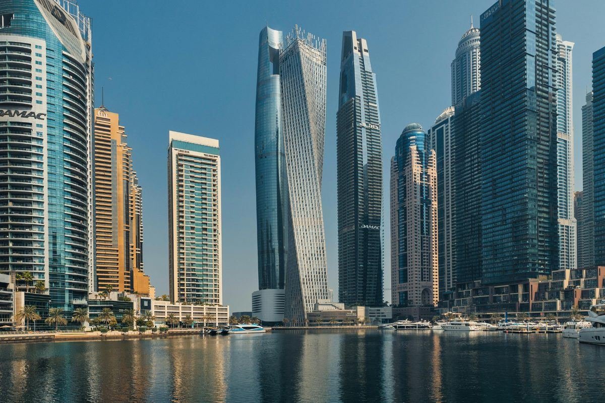 Dubai Marina waterfront residences with yachts at golden hour